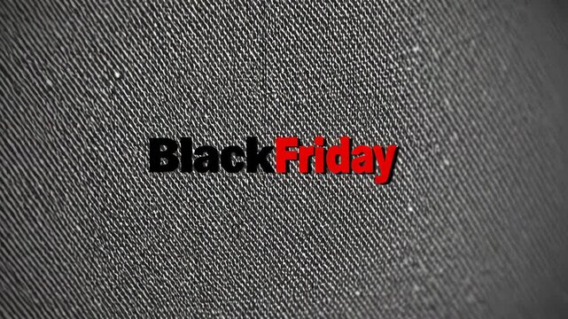 Black friday sale text fading on textured grey fabric, highlighting seasonal retail marketing campaign with dynamic visual communication about promotional shopping event