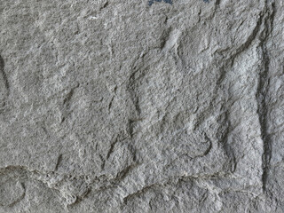 Close up of natural grey and black stone granite with 3D texture. Giant grey and black rock stone slab, natural pattern suitable for floor and wall material finishes. Seamless background texture.