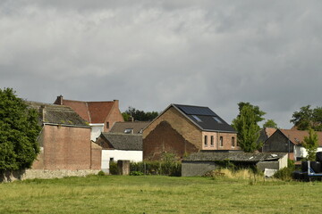 Obraz premium Ciel gris sur les toits des maisons et fermes à Hellebecq (Silly)