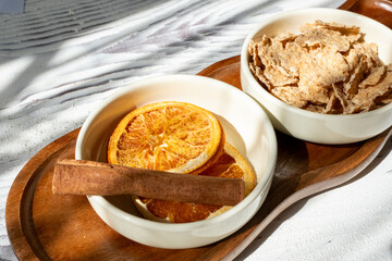 honey dripping from a white spoon and orange dried