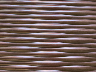 Close up of wavy 3D carved wall panel in dark brown and bronze metallic color paint finish. Seamless background texture. 