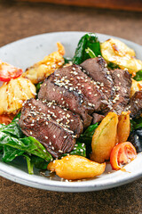 Portion of roast beef dish with vegetables garnish