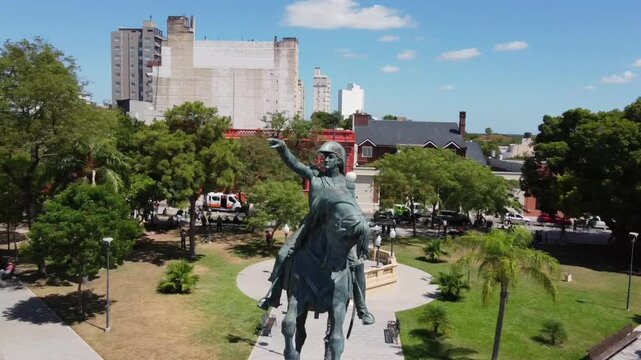 Drone orbits the equestrian statue of General San Martin in Plaza 25 de Mayo Corrientes finally revealing the Church of La Merced in the background