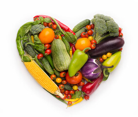 Healty diet concept. Heart shape frame of fresh vegetables on white background
