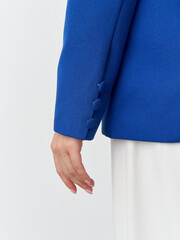Elegant hand detail showcases modern fashion in a vibrant blue blazer