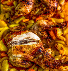 Spatchcocked herb-marinated chicken with golden potato wedges and caramelised sweet potato chunks roasting in savoury pan juices