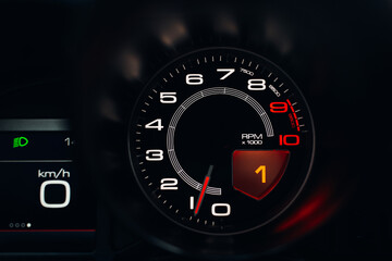Modern car close up view of tachometer and speedometer carbon dashboard with backlight