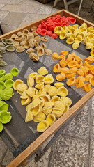 Orecchiette on a drying rack. Demonstration of the famous Apulian orecchiette, common in Italy. Varieties of fresh pasta. Italian pasta in the shape of small ears. Handmade orecchiette pasta