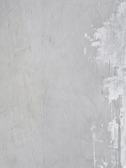 Background of old cement wall hasn't been finished with painted. Damaged cement wall with uneven paint and not full cover. Rough surface texture of cement wall in the process of repair and repainting.