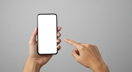 Hand holding smartphone with blank screen against gray background  
