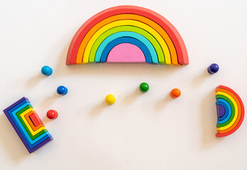 Colorful wooden rainbow toys arranged playfully on a light background showcasing vibrant colors and playful design in a bright and cheerful setting