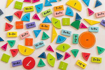 Colorful educational math manipulatives arranged on a white surface, promoting learning through hands-on activities and visual engagement. education,  back to school