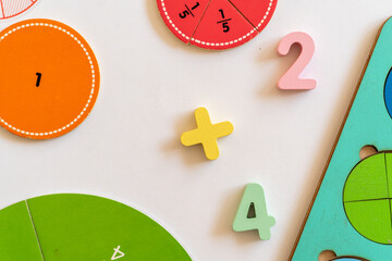 Colorful educational toys and numbers promoting early math skills on a white table