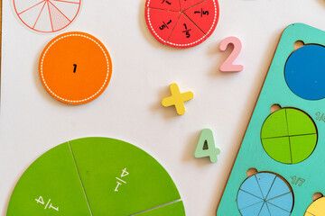 Colorful educational tools for learning fractions and simple math at a study table.  education,  back to school