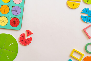Colorful educational manipulatives for teaching fractions on a white surface in a classroom setting during daytime. education,  back to school