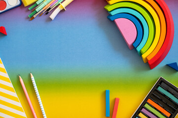 Colorful art supplies arranged on a bright gradient background, showcasing creativity and inspiration for artists and children