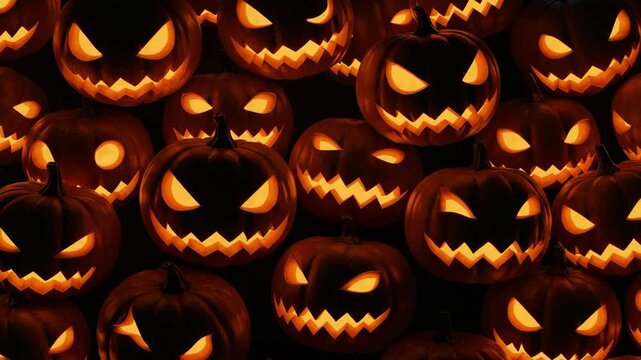 A multitude of carved Halloween pumpkins with glowing faces in the dark