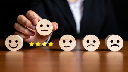 customer services best excellent business rating experience. Satisfaction survey concept. Hand of a businessman chooses a smile face on wood block circle. 5 Star Satisfaction.
