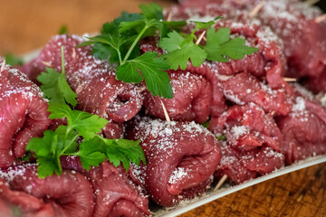 Horse meat Braciole or Brasciole, are a typical dish from the province of Bari in Puglia. Braciole are bundles of meat, stuffed with a mixture of parsley, garlic, and cheese in a butcher's for sale