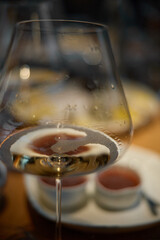 A glass of sparkling wine in close-up, Champagne tasting, Wine glasses are on the table, stylish table setting, sparkling wine bubbles, oysters and sea urchins, special sauce