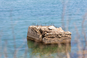 Decaying block of reinforced concrete in the tranquil waters of the Baltic Sea at Darß Peninsula beach in Germany