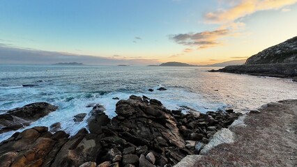 A Serene Coastal Sunset Over a Beautiful Rocky Shoreline, Capturing Natures Splendor