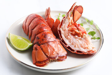 Delicious tails of boiled lobsters served on white table, closeup