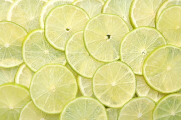 Slices of fresh limes as background, top view