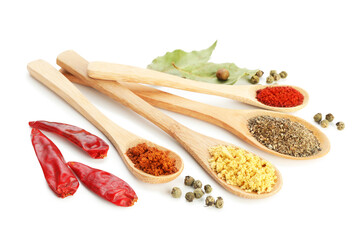Different aromatic spices in spoons isolated on white