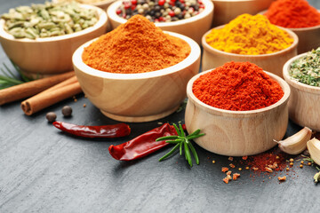 Different aromatic spices on black table, closeup