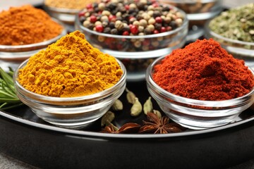 Different aromatic spices on light grey table, closeup