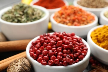 Different aromatic spices in bowls on table, closeup