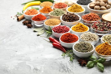 Different aromatic spices on grey table, closeup. Space for text