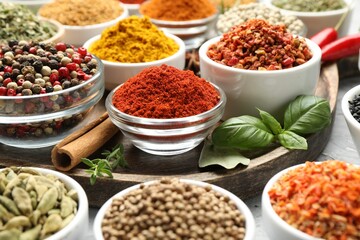 Different aromatic spices in bowls on table, closeup