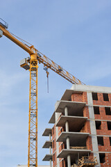 Construction of a modern building with a crane in a clear sky during daytime