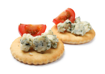 Tasty crackers with blue cheese and tomatoes isolated on white