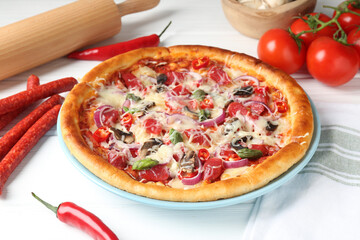 Tasty pizza with thin smoked sausages and ingredients on white table, closeup