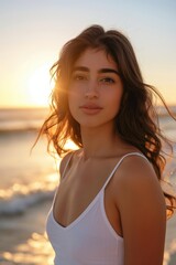 Naklejka premium Woman standing on shore in sunset light. Peaceful summer travel mood.