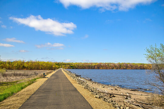 Sunny Spring landscape view of the Mississippi River Greenway Trail crossing a levee near Hastings, Minnesota.