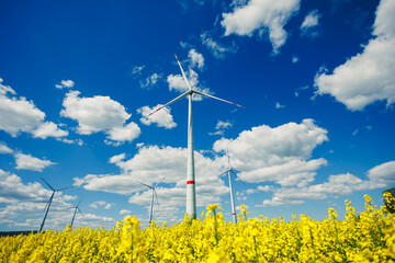 Wind turbine field. Wind turbines generating energy against a clear blue sky. Wind turbines generating clean renewable energy in a rural field.