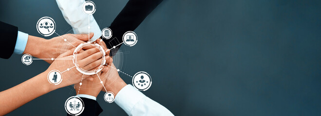 This image illustrates the concept of teamwork with diverse hands joining together, surrounded by...