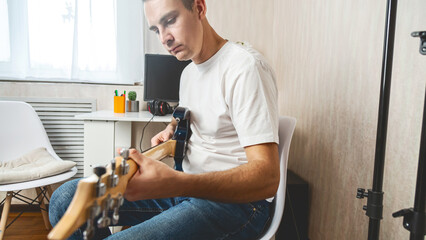 Musician, guitarist or man studying at home for performance practice, hobby or solo track with...