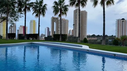Enjoy a stunning pool view with soaring skyscrapers and vibrant palm trees enhancing beauty