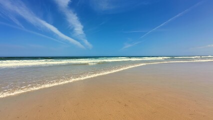 A Serene Beach Landscape Featuring Clear Blue Skies and Gentle, Soothing Waves Nearby