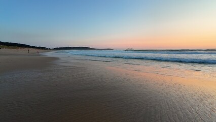 A Beautifully Serene Beach at Sunset with Calm Waves and Tranquil Skies to Enjoy