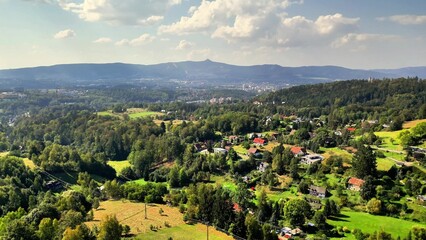 This is a scenic overview showcasing a lush green valley set beneath a bright, expansive sky