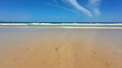 Enjoy a Serene Beach featuring Gentle Waves alongside a Clear Blue Sky filled with scenery