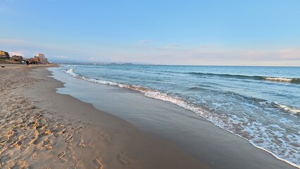 A Beautiful and Serene Beach View Featuring Gentle Waves and Soft, Warm Sand Underfoot