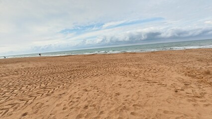A Serene Beach Landscape Featuring Calm Waters, Soft Waves, and Beautiful Cloudy Skies