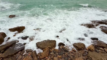 The Beautiful Waves Crashing on the Rocky Shoreline in a Serene and Peaceful Coastal Setting